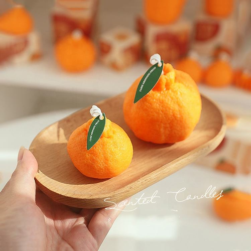 Orange-scented candles, perfect for holiday gifts, parties, and home décor.