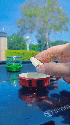 Solar-powered double-ring suspended rotating aromatherapy car air freshener with gradient lighting, long-lasting subtle fragrance, and decorative car interior ornament.