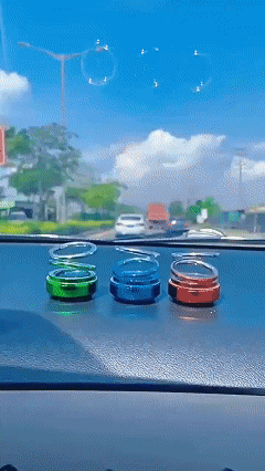 Solar-powered double-ring suspended rotating aromatherapy car air freshener with gradient lighting, long-lasting subtle fragrance, and decorative car interior ornament.