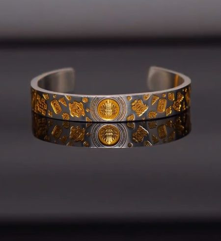 ✨ Lucky Bracelet – Bringing Good Fortune and Prosperity ✨  An elegant design featuring a silver base accented with exquisite gold-plated motifs 💛  The bracelet is engraved with symbols representing wealth, good luck, and prosperity—combining aesthetic beauty with deep, auspicious meaning.  💰 Wealth – Good Luck – Auspiciousness  ✨ A striking design that looks incredibly elegant when worn  🎁 Perfect as a gift for family, friends, or yourself.