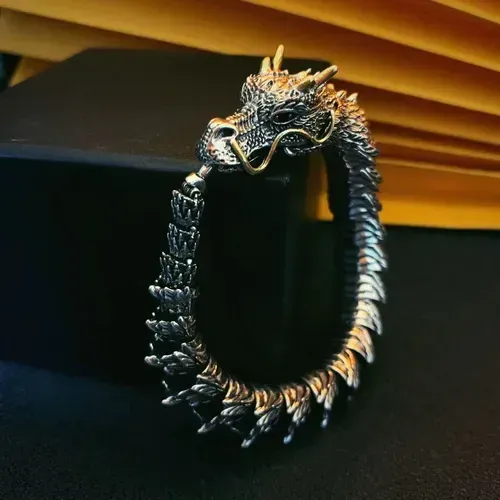 Dragon - shaped bracelet: winding dragon form, golden - horned & bearded head with blue gem eyes, retro and domineering design, dragon - scale - like texture, trendy men's jewelry.