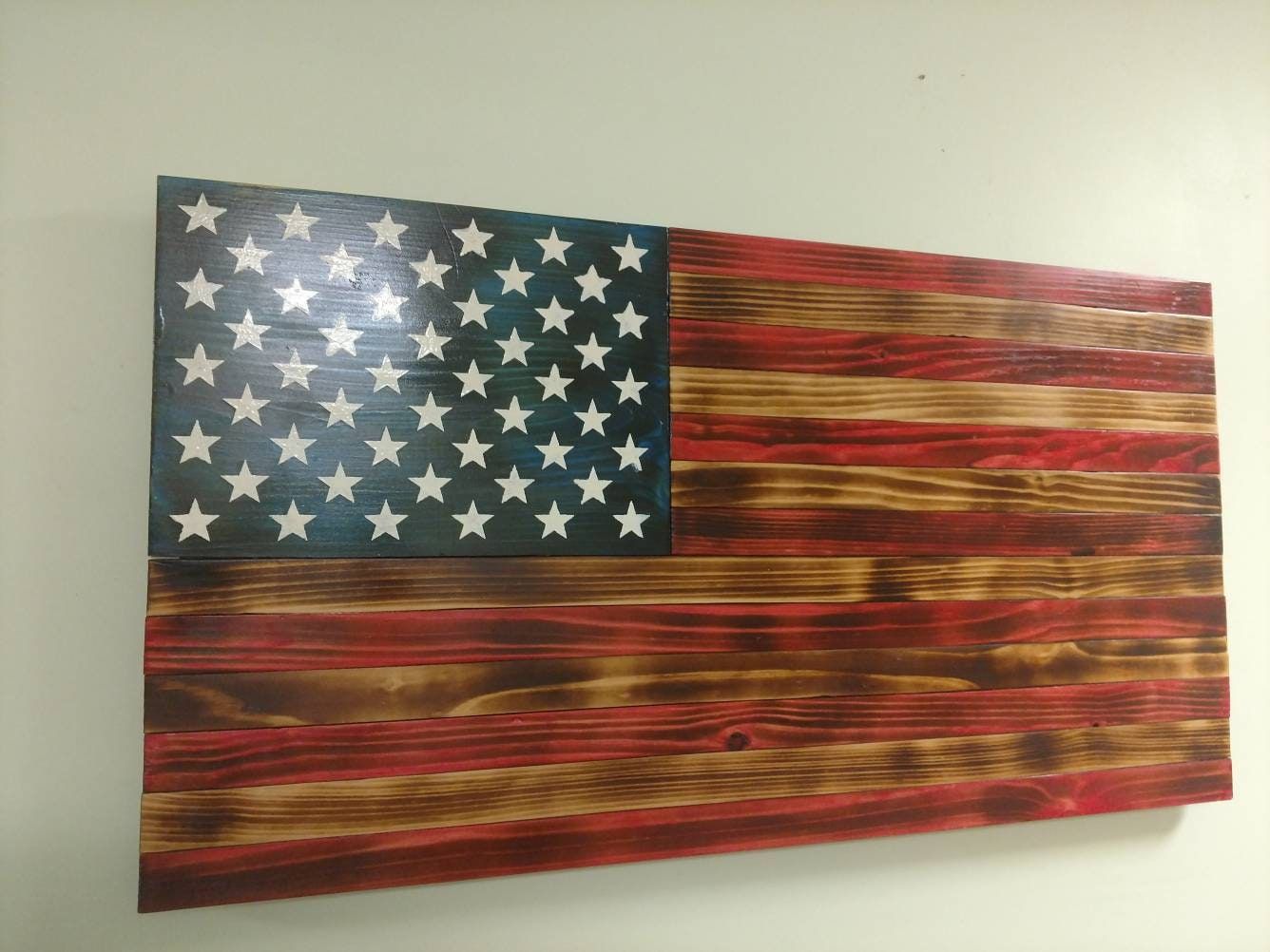 Stained and burned wooden American flag