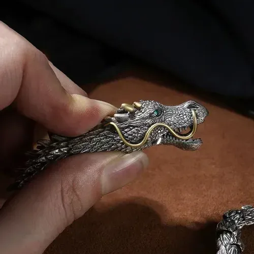 Dragon - shaped bracelet: winding dragon form, golden - horned & bearded head with blue gem eyes, retro and domineering design, dragon - scale - like texture, trendy men's jewelry.