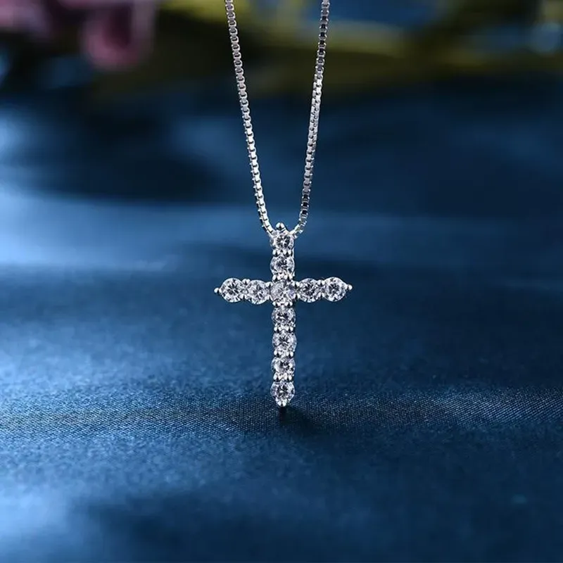 A cross pendant necklace entirely set with diamonds